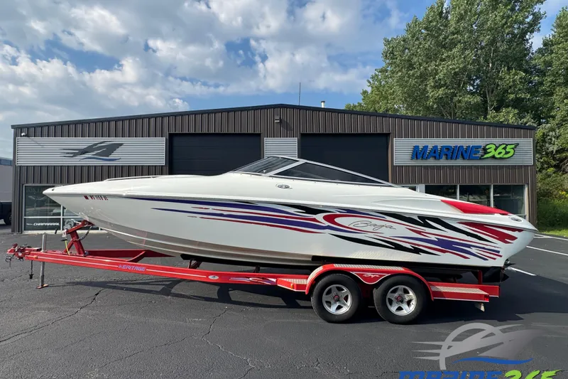 Slide: The Image of 2004 Baja 275 speedboat on trailer, vibrant graphics, parked at Marine 365 dealership. - 0