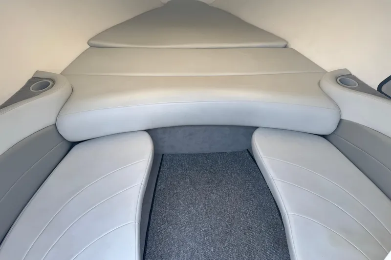 Slide: The Image of 2004 Baja 275 boat interior with gray cushioned seating and carpeted flooring. - 13