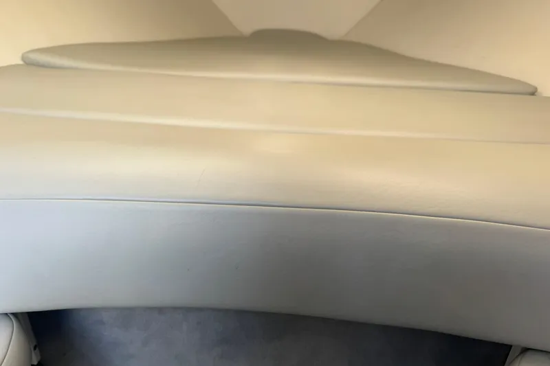 Slide: The Image of Interior view of a 2004 Baja 275 boat, featuring beige upholstery. - 18