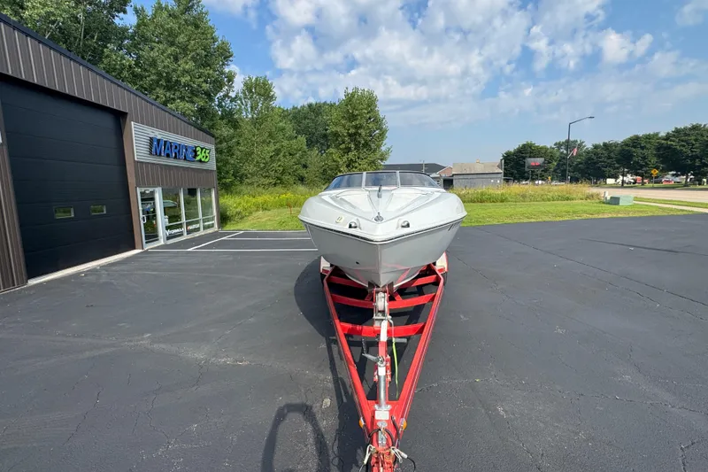 Slide: The Image of 2004 Baja 275 boat on red trailer outside Marine 365 dealership. - 2