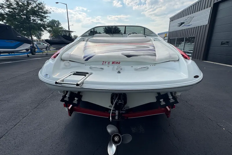 Slide: The Image of 2004 Baja 275 boat rear view with "It's Mine" text, parked outdoors. - 6