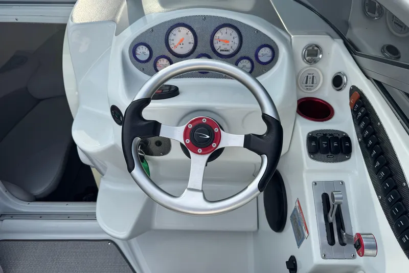 Slide: The Image of 2004 Baja 275 boat dashboard with steering wheel and control panel. - 9