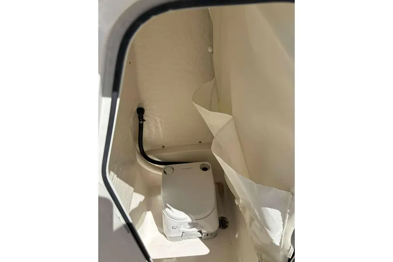 Slide: The Image of 2024 Key West 203 FS boat interior with compact toilet setup. - 10
