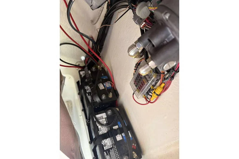 Slide: The Image of 2024 Key West 203 FS boat battery compartment with wiring and connections. - 11