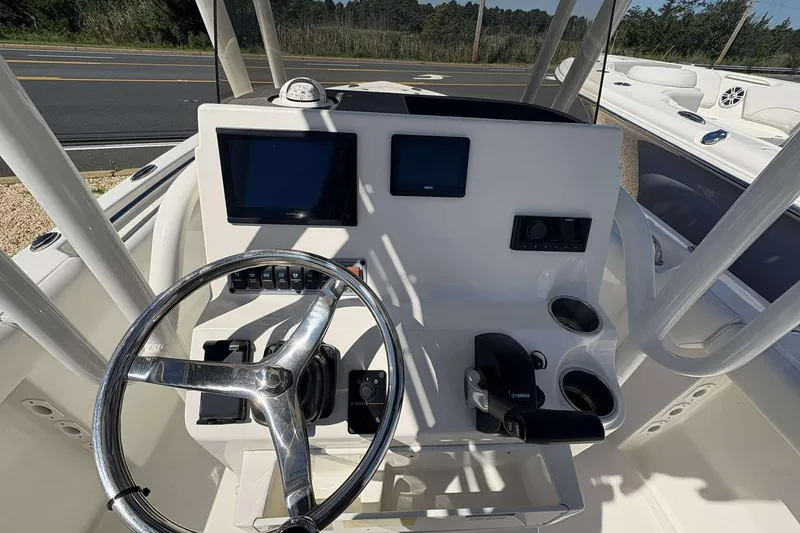 Slide: The Image of 2024 Key West 203 FS boat dashboard with steering wheel and electronic displays. - 12