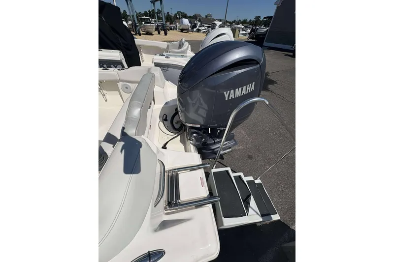 Slide: The Image of 2024 Key West 203 FS boat with Yamaha outboard motor and swim ladder. - 14