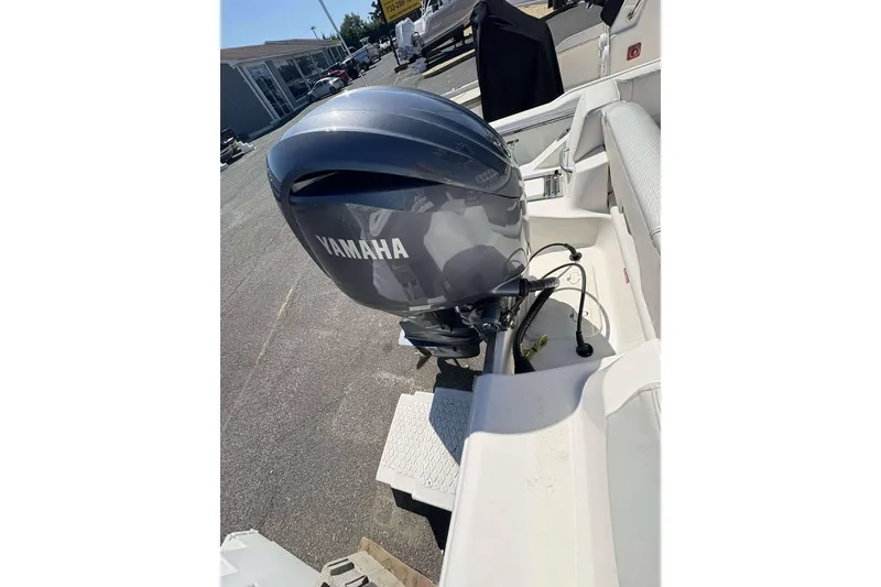 Slide: The Image of 2024 Key West 203 FS boat with Yamaha outboard motor, parked outdoors. - 16