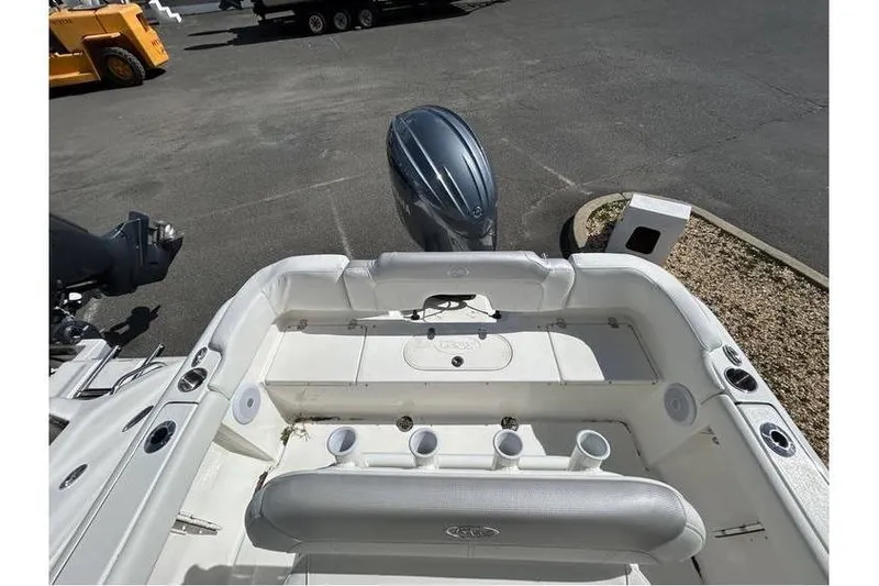 Slide: The Image of 2024 Key West 203 FS boat interior with motor, featuring seating and cup holders. - 5