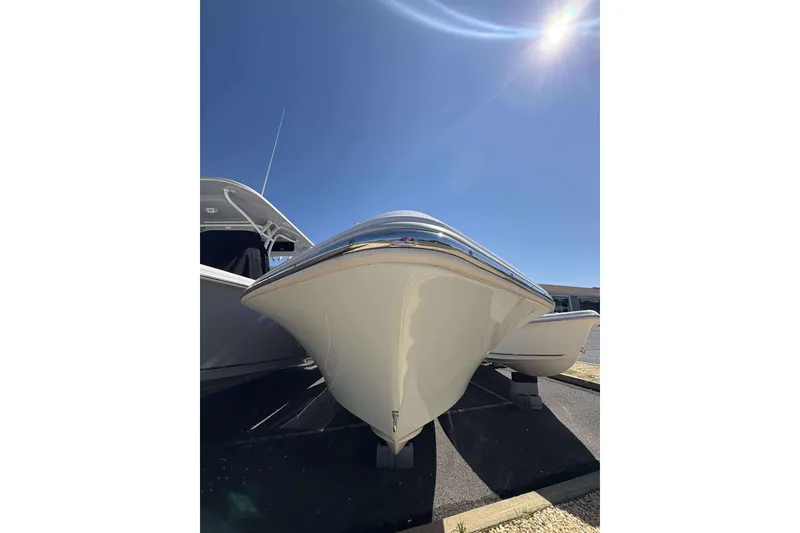 Slide: The Image of 2024 Key West 203 FS boat under bright blue sky, front view. - 8