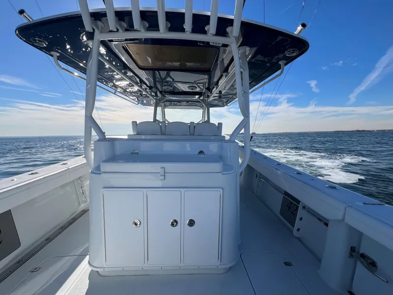 Slide: The Image of 2023 Yellowfin 42 Offshore boat interior with ocean view and clear blue sky. - 11