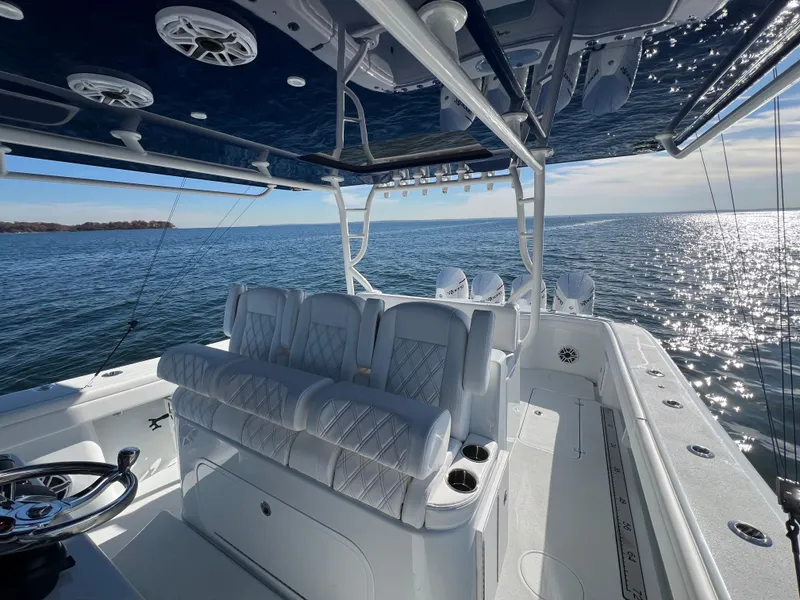 Slide: The Image of 2023 Yellowfin 42 Offshore boat interior with luxurious seating on open water. - 13
