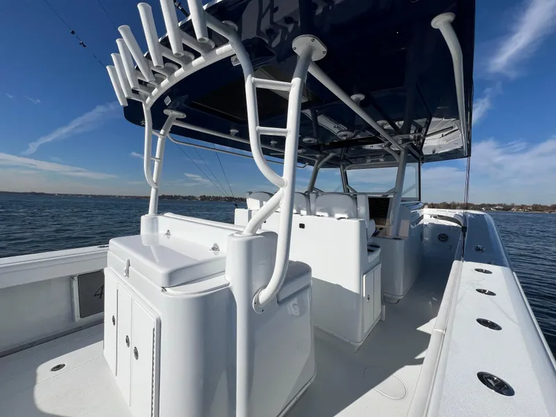 Slide: The Image of 2023 Yellowfin 42 Offshore boat with rod holders, sleek design, and spacious deck on open water. - 14