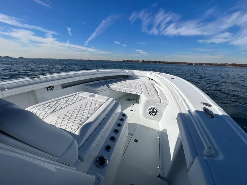 Slide: The Image of 2023 Yellowfin 42 Offshore boat on open water under clear blue sky. - 15