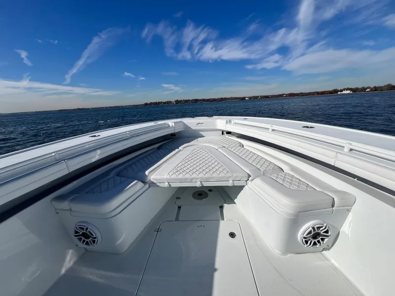 Slide: The Image of 2023 Yellowfin 42 Offshore boat with cushioned seating on open water. - 16