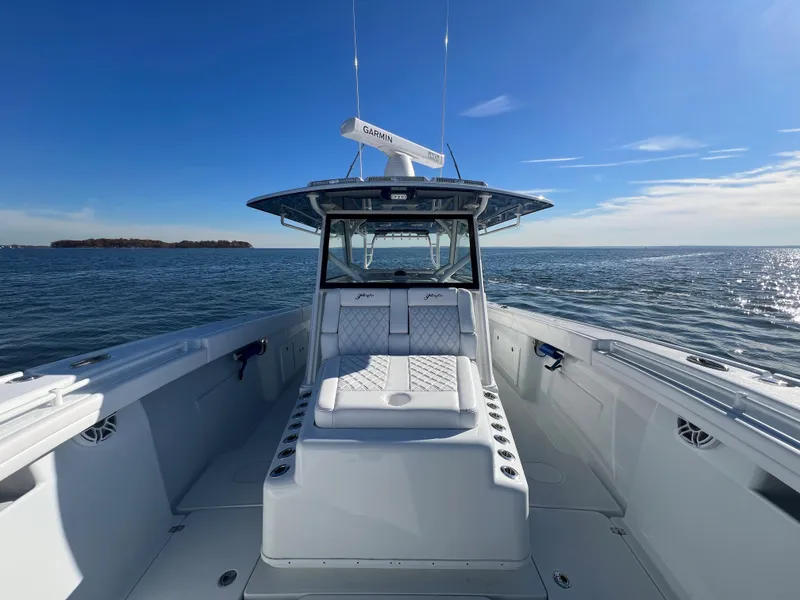 Slide: The Image of 2023 Yellowfin 42 Offshore boat on open water, clear sky, luxurious seating. - 17