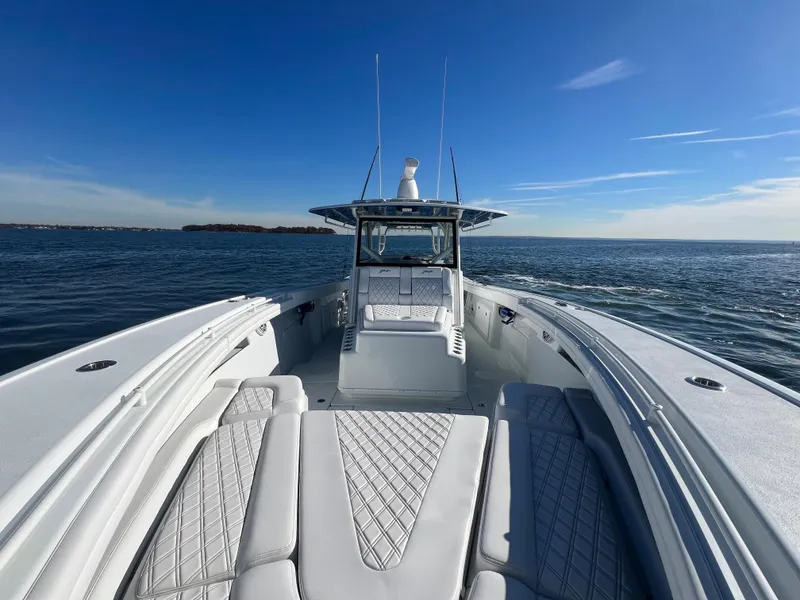 Slide: The Image of 2023 Yellowfin 42 Offshore boat on open water under clear blue sky. - 18