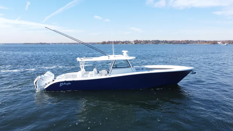 Slide: The Image of 2023 Yellowfin 42 Offshore boat on open water, side view. - 3