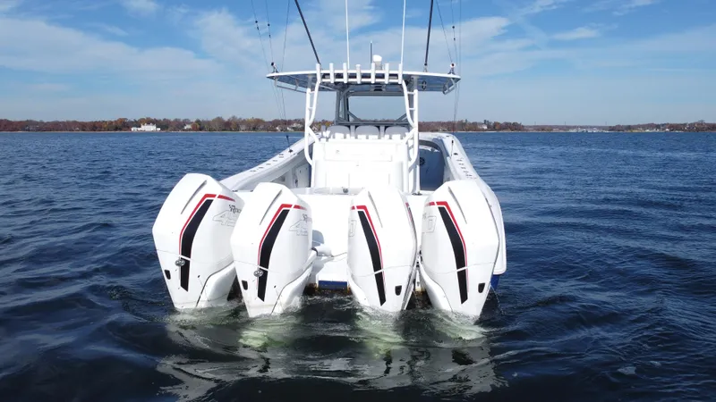 Slide: The Image of 2023 Yellowfin 42 Offshore boat with four powerful outboard engines on open water. - 4