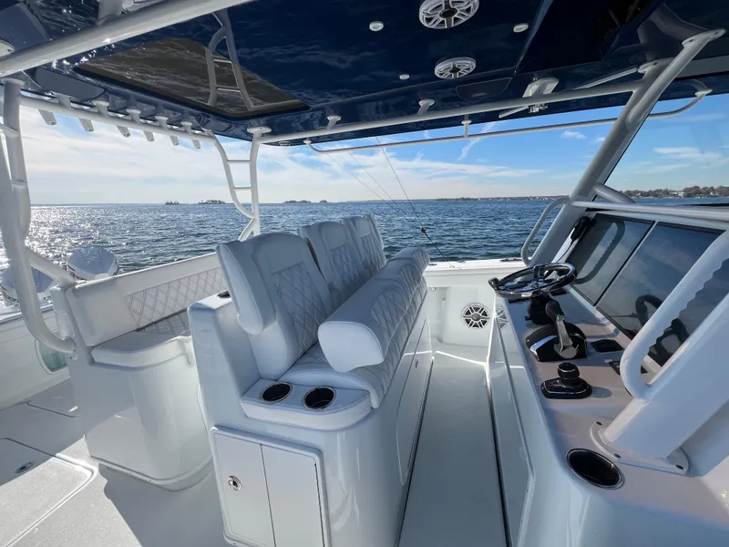 Slide: The Image of 2023 Yellowfin 42 Offshore boat interior with helm, seating, and ocean view. - 5