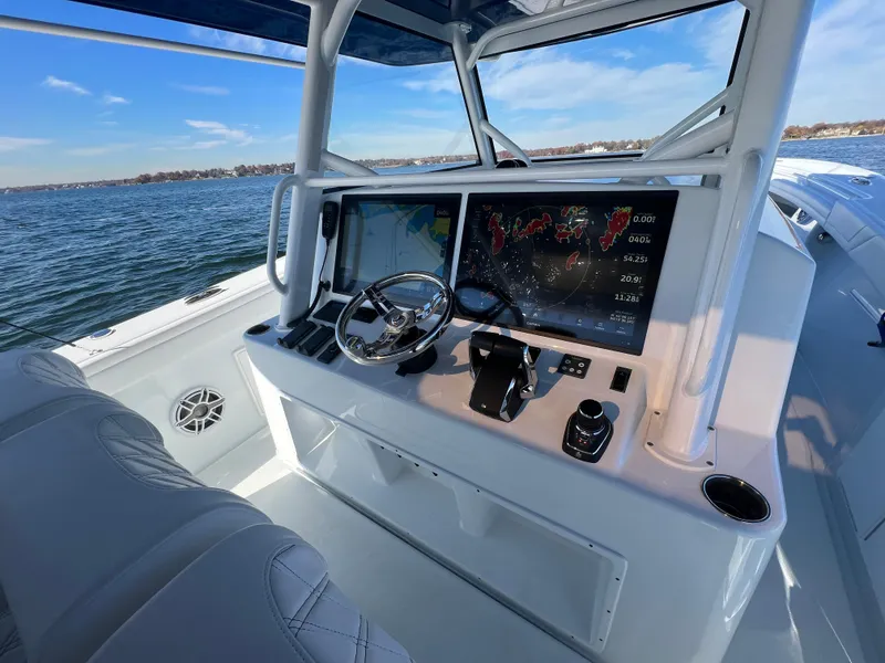 Slide: The Image of 2023 Yellowfin 42 Offshore boat cockpit with advanced navigation system on open water. - 6
