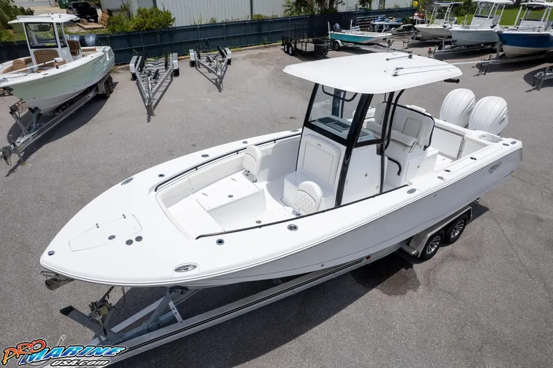 Slide: The Image of 2026 Sea Hunt Gamefish 27 Coffin Box boat on trailer, featuring dual engines and spacious deck. - 1