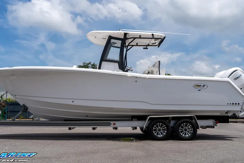 Slide: The Image of 2026 Sea Hunt Gamefish 27 Coffin Box boat on trailer under blue sky. - 13
