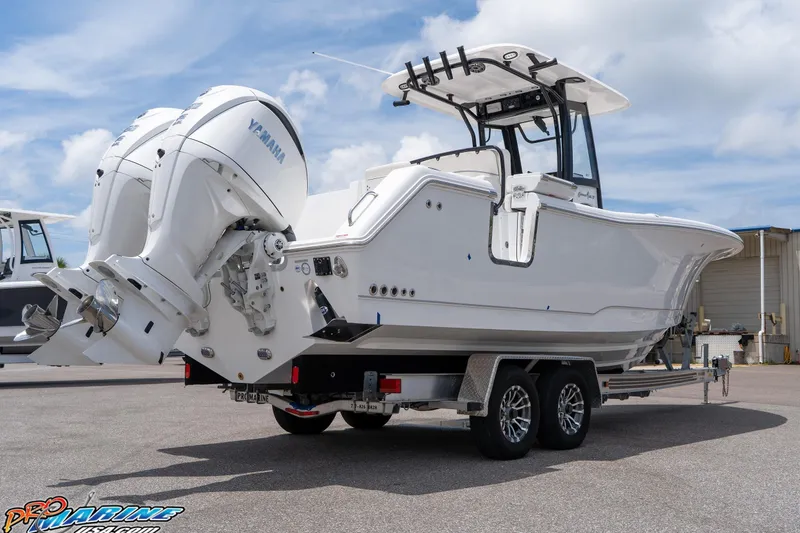 Slide: The Image of 2026 Sea Hunt Gamefish 27 Coffin Box boat with dual Yamaha engines on a trailer. - 16