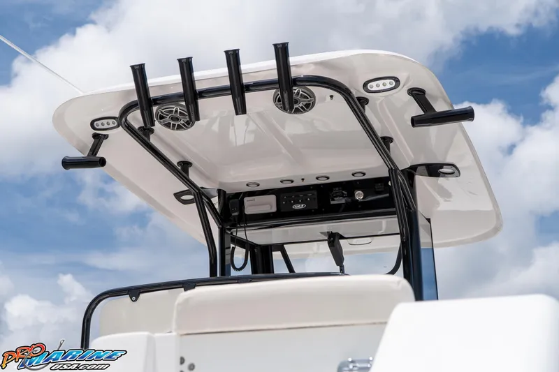 Slide: The Image of 2026 Sea Hunt Gamefish 27 Coffin Box boat with T-top and rod holders against blue sky. - 20