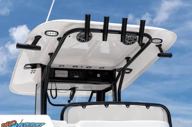 Slide: The Image of 2026 Sea Hunt Gamefish 27 Coffin Box boat with rod holders and speakers against blue sky. - 21