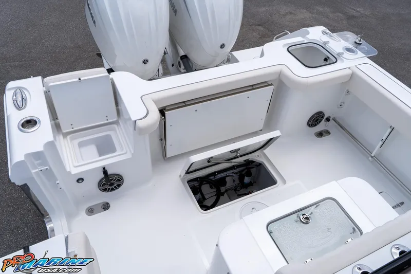 Slide: The Image of 2026 Sea Hunt Gamefish 27 Coffin Box boat deck with storage and dual engines. - 23