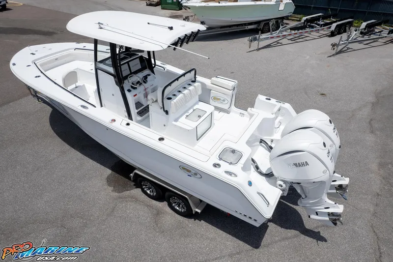 Slide: The Image of 2026 Sea Hunt Gamefish 27 Coffin Box boat with dual Yamaha engines on trailer. - 3
