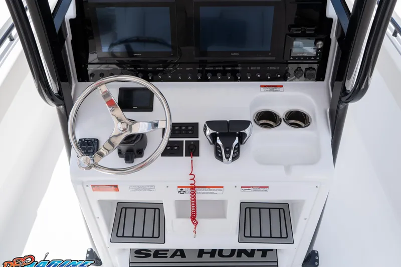 Slide: The Image of 2026 Sea Hunt Gamefish 27 Coffin Box helm with steering wheel and dual screens. - 33
