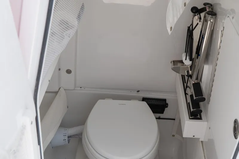 Slide: The Image of Interior of 2026 Sea Hunt Gamefish 27 Coffin Box, featuring compact marine toilet setup. - 42