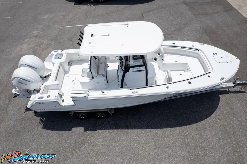 Slide: The Image of 2026 Sea Hunt Gamefish 27 Coffin Box boat with dual Yamaha engines, parked on a trailer. - 6