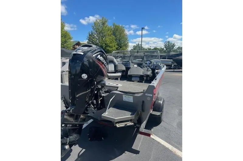 Slide: The Image of 2019 Crestliner 1700 Vision boat with Mercury outboard motor, parked outdoors. - 2