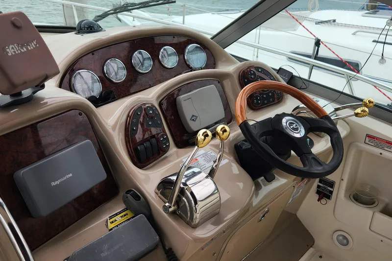 Slide: The Image of Control panel of a 2005 Sea Ray 320 Sundancer boat with steering wheel and gauges. - 3
