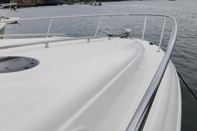 Slide: The Image of 2005 Sea Ray 320 Sundancer boat deck with railing, overlooking calm water. - 5