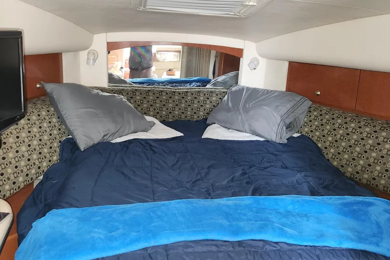 Slide: The Image of Cozy cabin interior of 2005 Sea Ray 320 Sundancer with bed and pillows. - 9