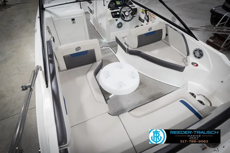 Slide: The Image of 2022 Hurricane 235RD boat interior with seating and steering console, showcased by Reeder-Trausch Marine. - 14
