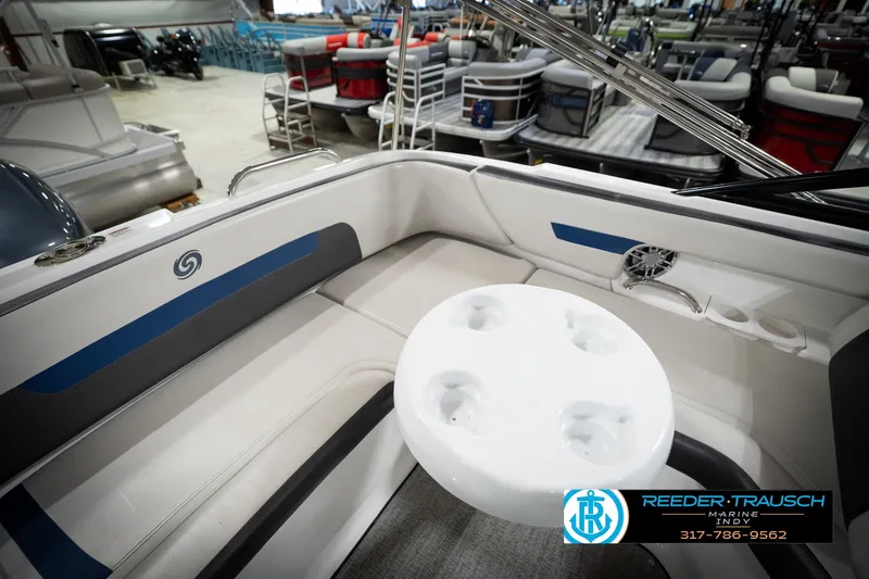Slide: The Image of Interior of 2022 Hurricane 235RD boat with seating and cup holders in showroom. - 21