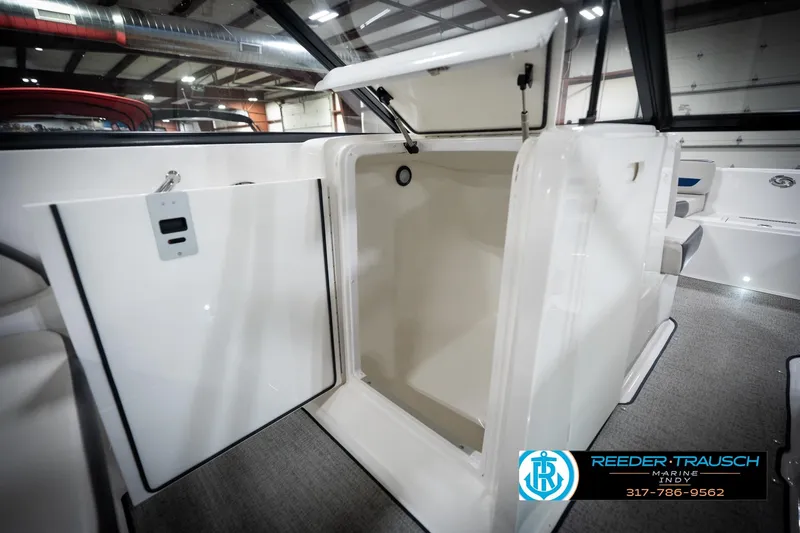 Slide: The Image of 2022 Hurricane 235RD boat interior storage compartment in showroom setting. - 26