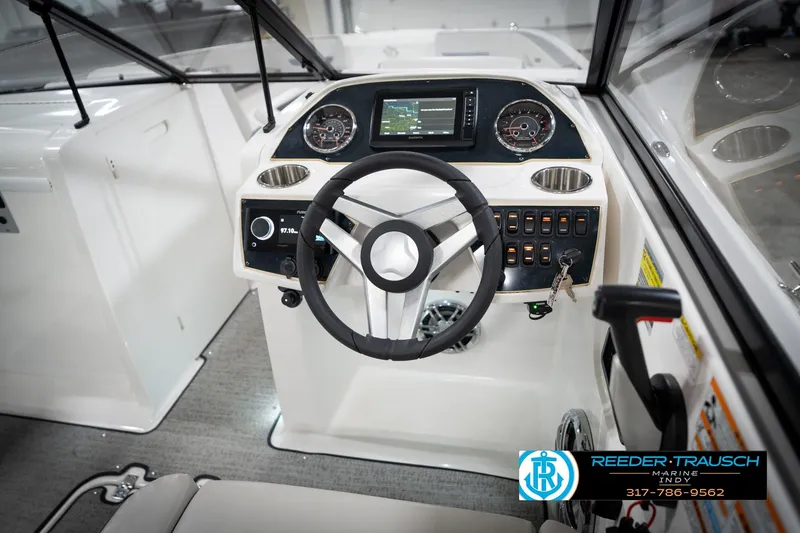 Slide: The Image of 2022 Hurricane 235RD boat dashboard with steering wheel and control panel. - 29