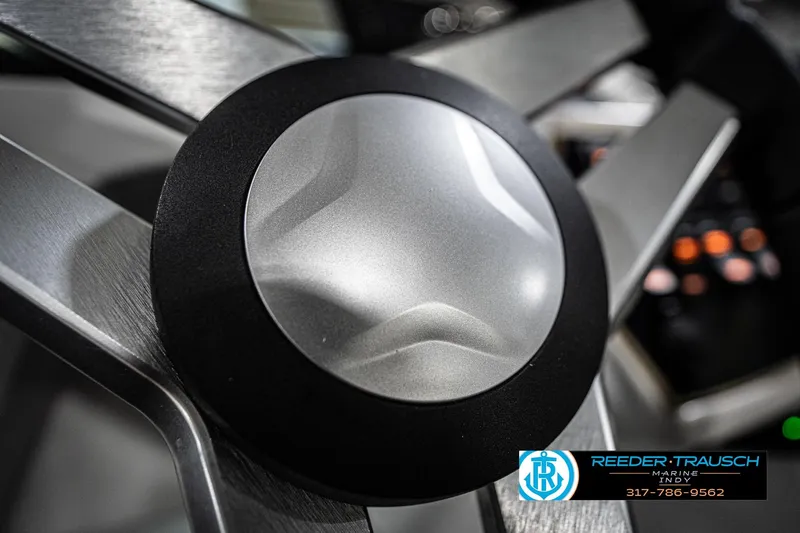 Slide: The Image of Close-up of 2022 Hurricane 235RD steering wheel with Reeder Trausch Marine logo. - 31