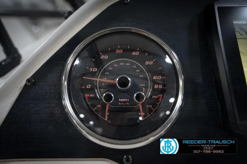 Slide: The Image of Close-up of 2022 Hurricane 235RD speedometer, displaying MPH and km/h, with Reeder-Trausch Marine logo. - 33
