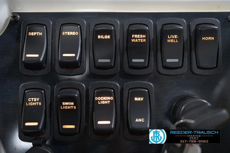 Slide: The Image of Control panel of 2022 Hurricane 235RD boat with labeled switches and key. - 37
