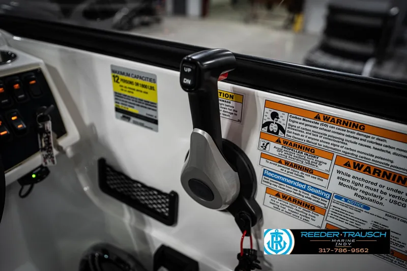Slide: The Image of Control panel of 2022 Hurricane 235RD boat with warning labels and throttle lever. - 38