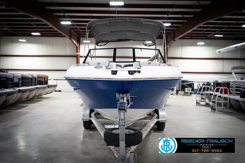 Slide: The Image of 2022 Hurricane 235RD boat in showroom, blue and white, on trailer, Reeder-Trausch Marine. - 4