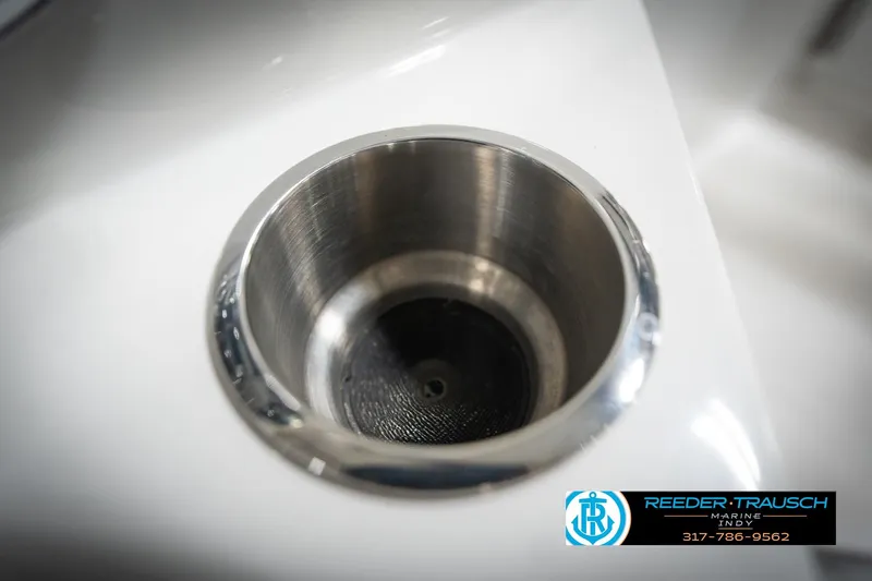 Slide: The Image of Close-up of a stainless steel cup holder on a 2022 Hurricane 235RD boat. - 44
