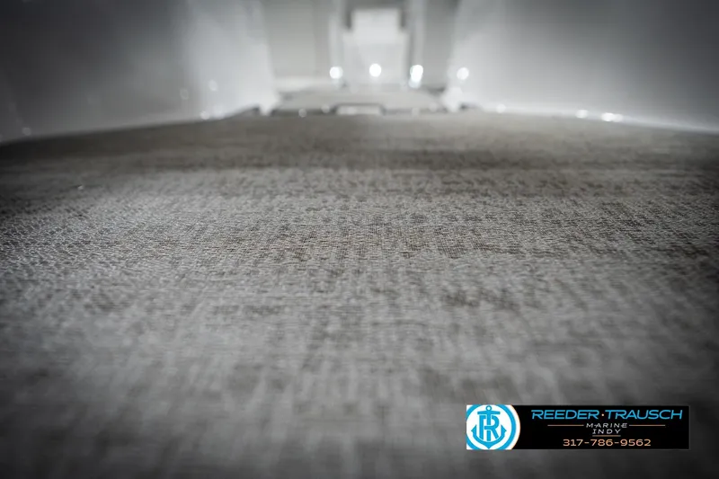 Slide: The Image of Carpeted interior of 2022 Hurricane 235RD boat, featuring Reeder Trausch Marine logo. - 46