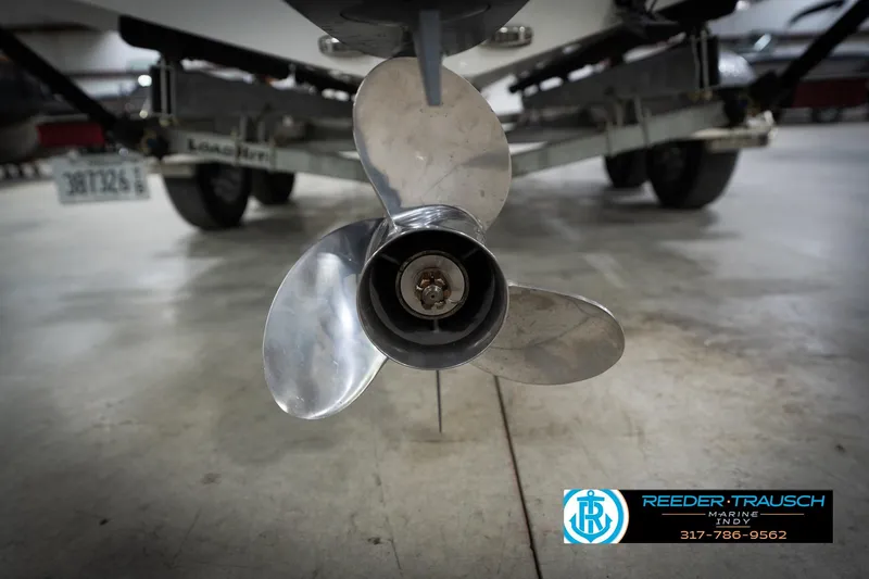 Slide: The Image of Close-up of a 2022 Hurricane 235RD boat propeller in a garage setting. - 51